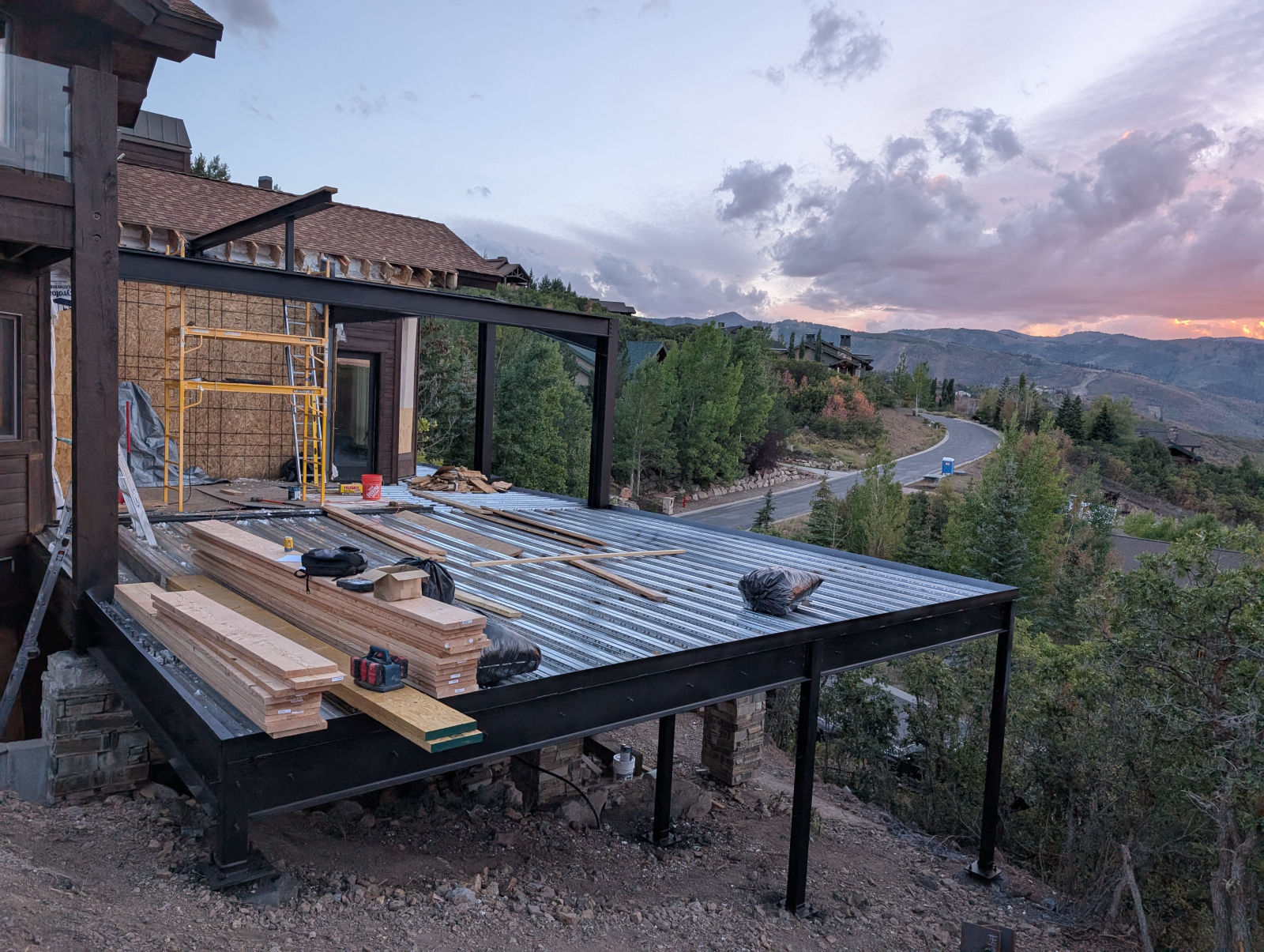 Elevated steel-framed deck and room addition over a sloped lot near Park City, Utah