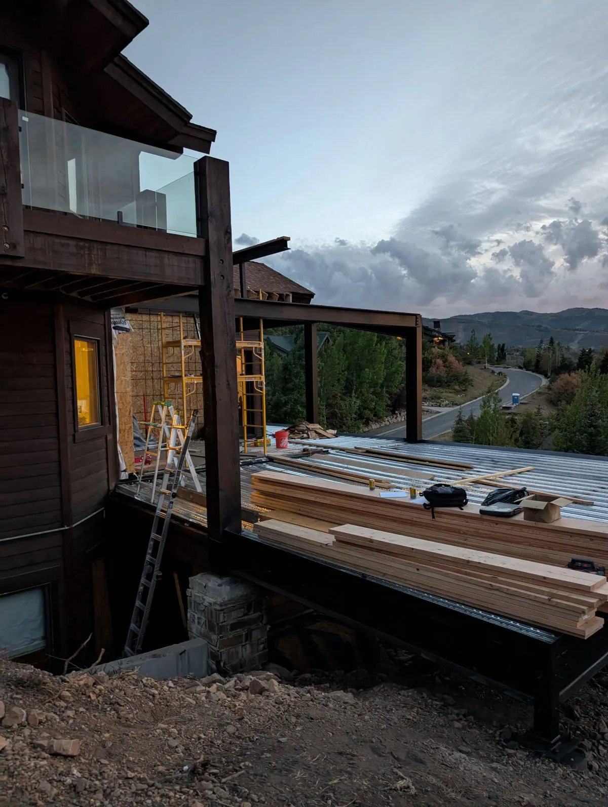 Cantilevered hillside addition — Cantilevered steel structure supporting an addition over a slope
